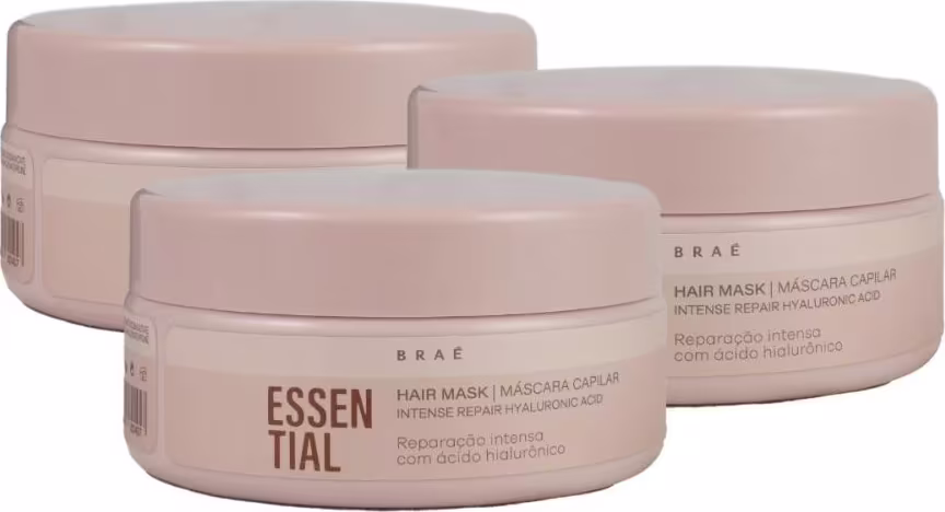 Três potes de máscara capilar da marca Braé, com embalagens redondas de cor rosa clara. Os rótulos exibem o nome "Essential" em destaque, indicando que se trata de um produto da linha Essential da marca.