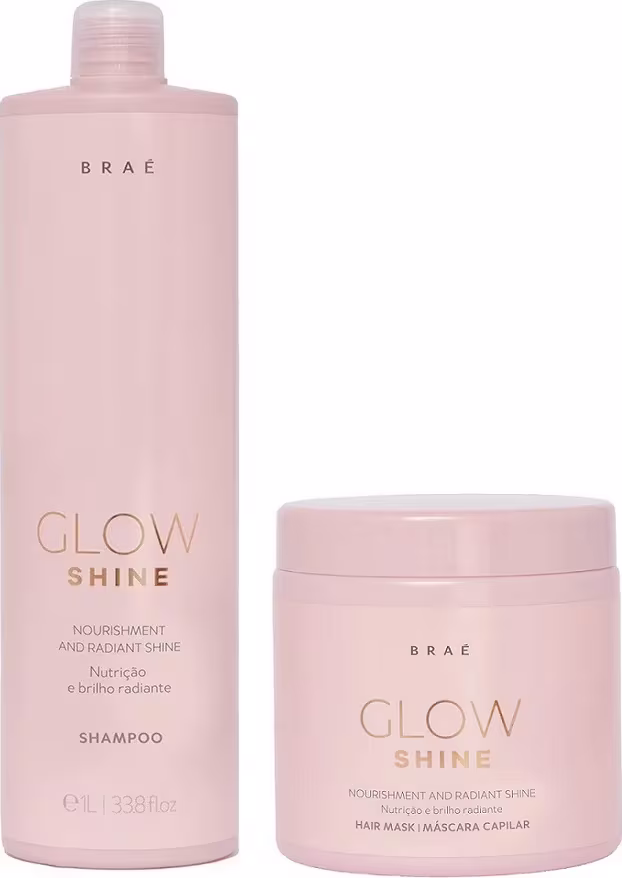 Dois produtos da marca Braé: um frasco de shampoo rosa claro com rótulo "Glow Shine" e um pote rosa claro com rótulo "Glow Shine Hair Mask", ambos com acabamento brilhante e textos em dourado.