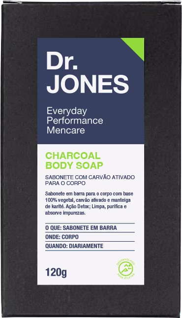 A imagem mostra uma barra de sabonete corporal Dr. Jones com carvão ativado. O produto vem uma embalagem de 120g, preta com detalhes em branco, verde e azul.