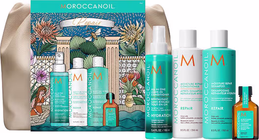 Caixa e produtos da marca Moroccanoil em embalagens com design floral e cores vibrantes, incluindo frasco de óleo, condicionador, shampoo e outros itens de cuidados com os cabelos.