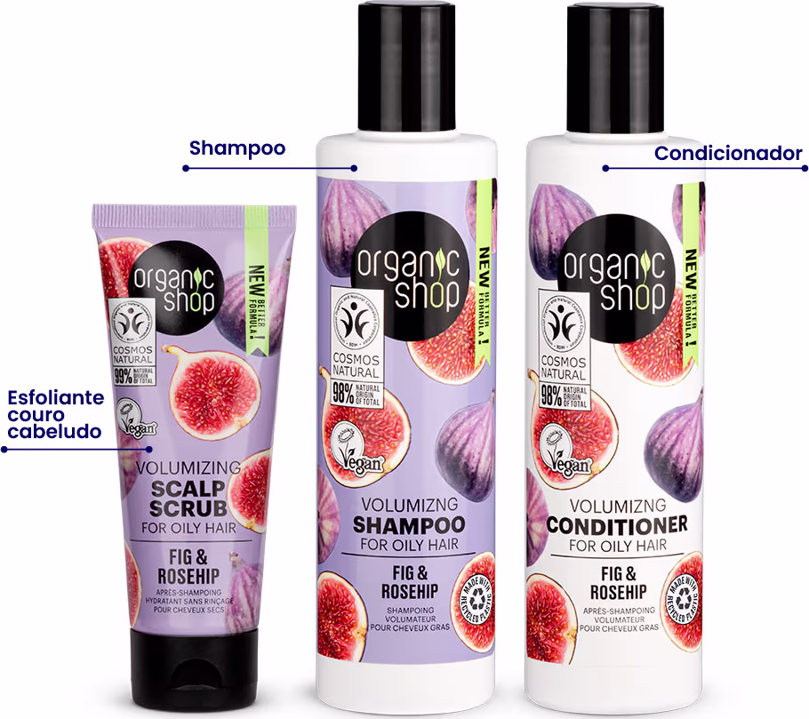 A imagem mostra um shampoo em frasco plástico branco com rótulo lilás e imagens de figo. O condicionador vem em frasco plástico branco similar, com rótulo branco e mesmas imagens. Por fim, o esfoliante capilar em tubo plástico lilás com imagens de figo.