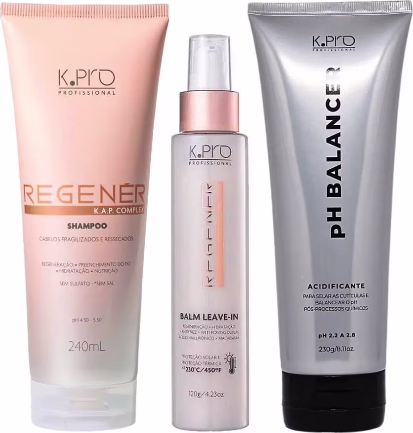 Conjunto de produtos de cuidados capilares da marca K.pro, incluindo shampoo e leave-in em embalagens de plástico nas cores rosa e branco. Também conta com tubo de acidificante pH Balancer.