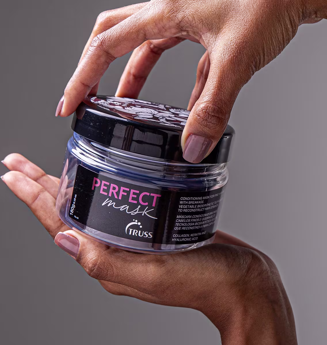 A imagem mostra um pote de um produto capilar chamado "Perfect Mask" da marca Truss. O pote está sendo segurado por uma mão. O produto é descrito como uma máscara condicionadora. Contém ingredientes como colágeno, keratina e ácido hialurônico.