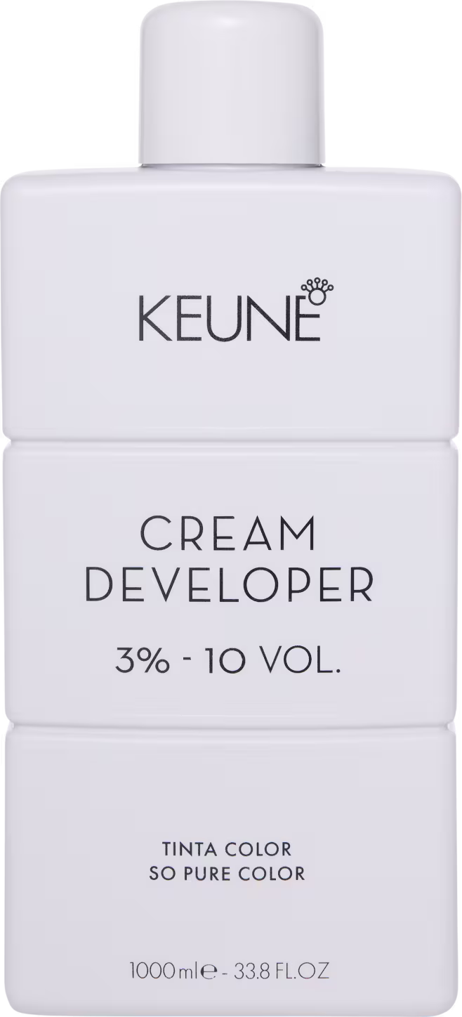 Frasco branco da marca Keune, contendo Cream Developer com 3% - 10 VOL. O rótulo apresenta o nome da marca e do produto em letras pretas.