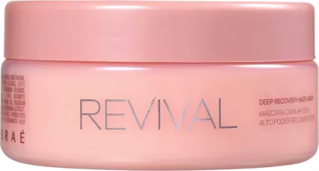 Rótulo com o nome "Revival" em letras cinzas e a descrição "Deep Reconstructing Hair Masque" abaixo, indicando ser uma máscara capilar reconstrutora profunda. Apresentação clean e minimalista, com destaque para a cor rosa suave característica da linha.