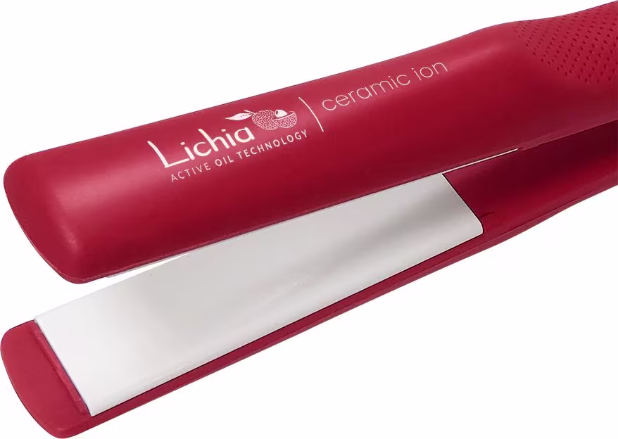 A imagem mostra no detalhe a placa alisadora branca que fica no interior da chapinha. Ela possui corpo alongado e cilíndrico com superfície texturizada. Rótulo na lateral com o nome da marca e da linha. Design elegante e moderno.