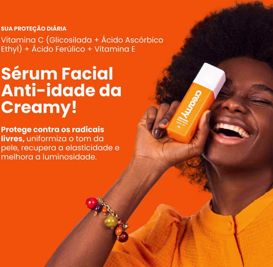 A imagem mostra uma mulher segurando um frasco retangular transparente de sérum cor laranja e tampa branca próximo ao rosto.