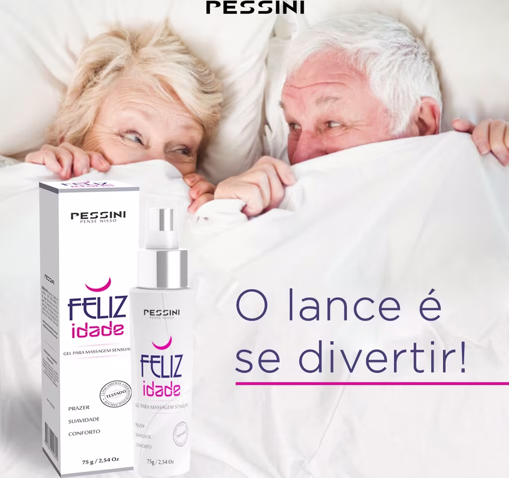 Um casal de idosos na cama, cobertos por um lençol branco, mostrando apenas os olhos e as mãos. Eles estão olhando um para o outro, com animação. Na frente, há o frasco do produto, com os dizeres "O lance é se divertir".