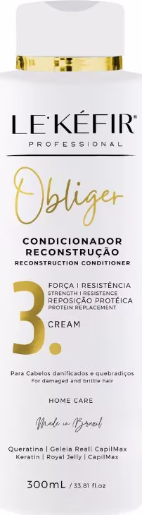A imagem mostra um frasco branco de condicionador. A embalagem contém 300ml e apresenta detalhes em letras douradas, com os principais ingredientes listados.