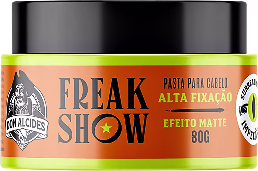 Pasta para cabelo da marca Don Alcides, com embalagem preta e laranja, rótulo com o nome "Freak Show" e informações sobre a alta fixação e efeito matte do produto.