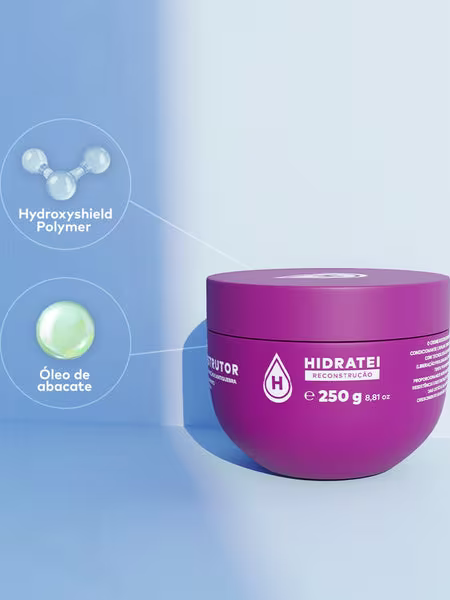 A imagem mostra o pote da máscara em um fundo branco. Ao lado são exibidos os principais ingredientes ativos: "Hidroxyshield Polymer" (um polímero hidratante) e "Óleo de abacate".