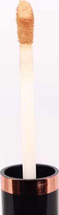 Pincel de maquiagem do corretivo com cabo longo e transparente. A extremidade possui um tufo felpudo e macio de cor bege claro. O cabo tem uma base preta com detalhes em tom cobreado.