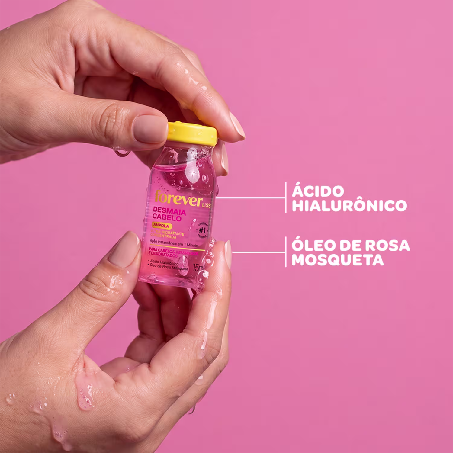 Frasco de 15ml da ampola Desmaia Cabelo da marca Forever Liss, com fórmula para cabelos ressecados e desidratados, contendo ácido hialurônico e óleo de rosa mosqueta, com tampa amarela e rótulo rosa.