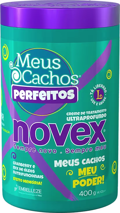 A imagem mostra o Creme de Tratamento Meus Cachos Perfeitos 400g da marca Novex. É uma embalagem cilíndrica com tons de verde e roxo. Destaca ser um produto com cranberry e mix de óleos com efeito memória para os cachos.