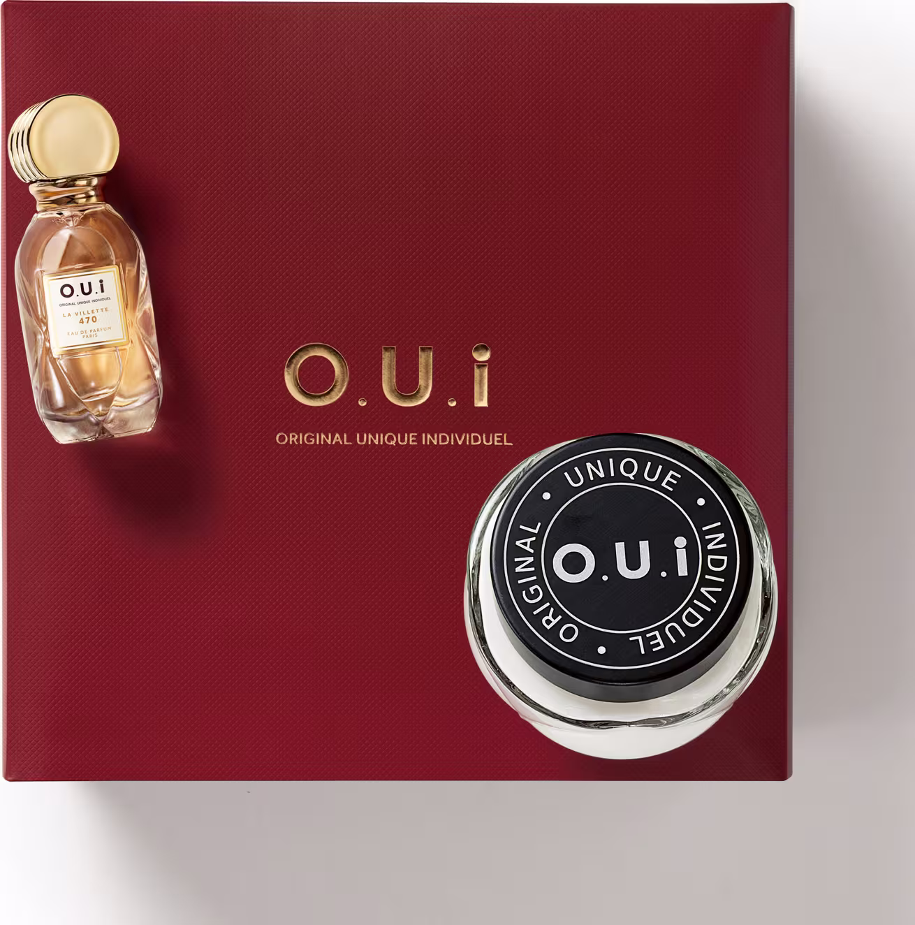 Frasco de perfume e uma caixa vermelha com o logotipo da marca. O frasco de perfume possui um design elegante com tampa dourada, enquanto a caixa vermelha destaca o nome da marca e a descrição "Original Unique Individuel".