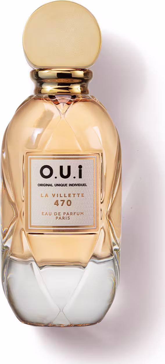 Frasco de perfume O.U.i. La Villette 470, com design elegante e dourado, contendo líquido âmbar. O rótulo apresenta o nome da marca e a descrição "Eau de Parfum Paris".