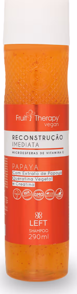 A imagem mostra uma embalagem de shampoo da linha Fruit Therapy Vegan. É um shampoo de Papaya destinado à reconstrução imediata dos cabelos. O frasco é laranja, com detalhes em branco com 290ml.
