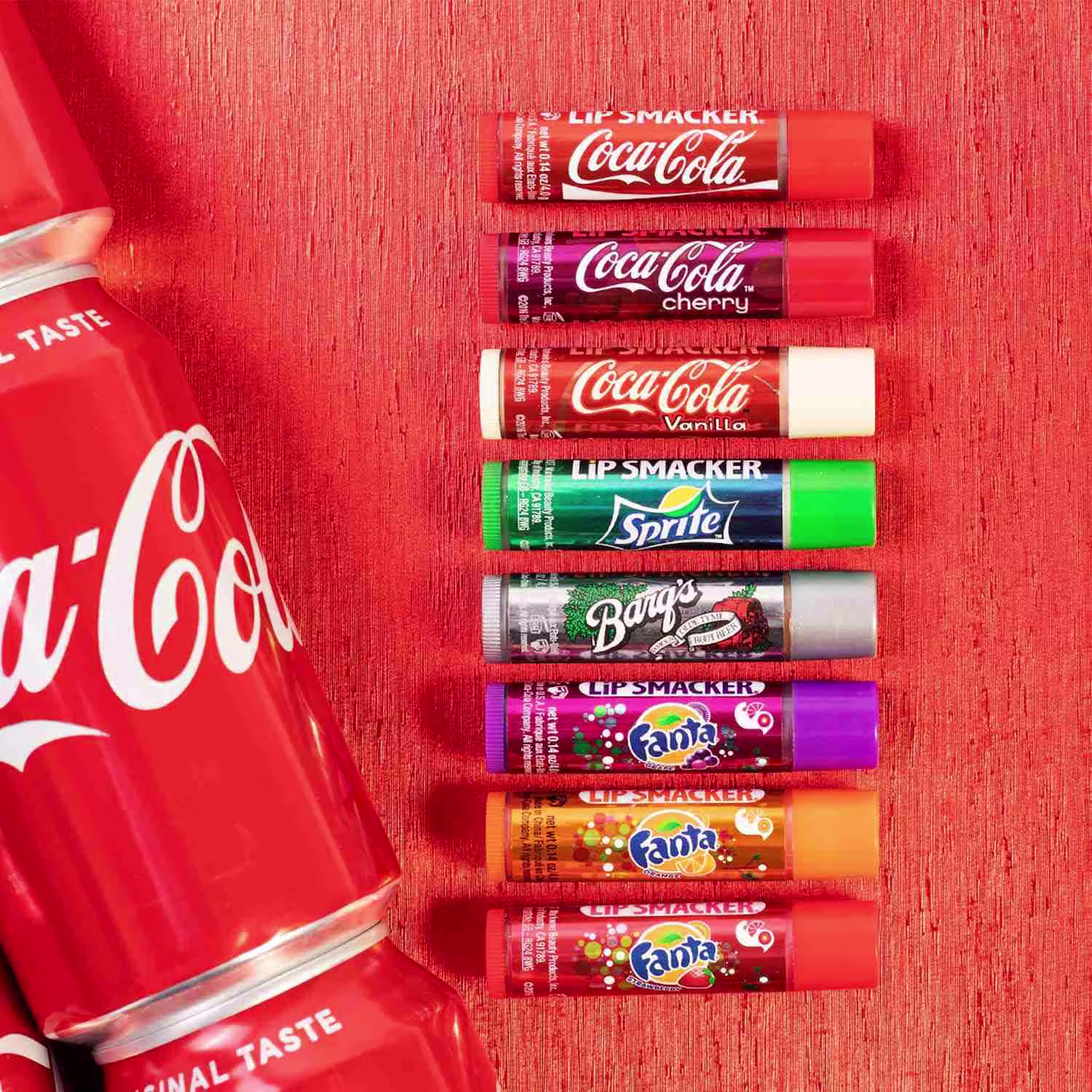 Este é um conjunto de batons lip smacker da Coca-Cola. O produto vem em uma embalagem vermelha com o logotipo "Lip Smacker Coca-Cola" em letras brancas. Inclui vários batons em formatos de bastão, com tampas coloridas.
