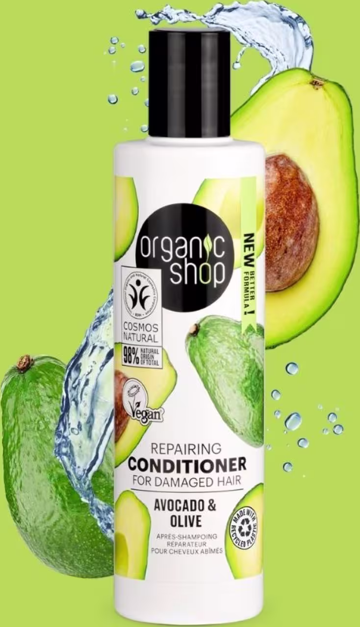 A imagem mostra o frasco em um fundo verde e ao redor algumas gotas de água e abacates.