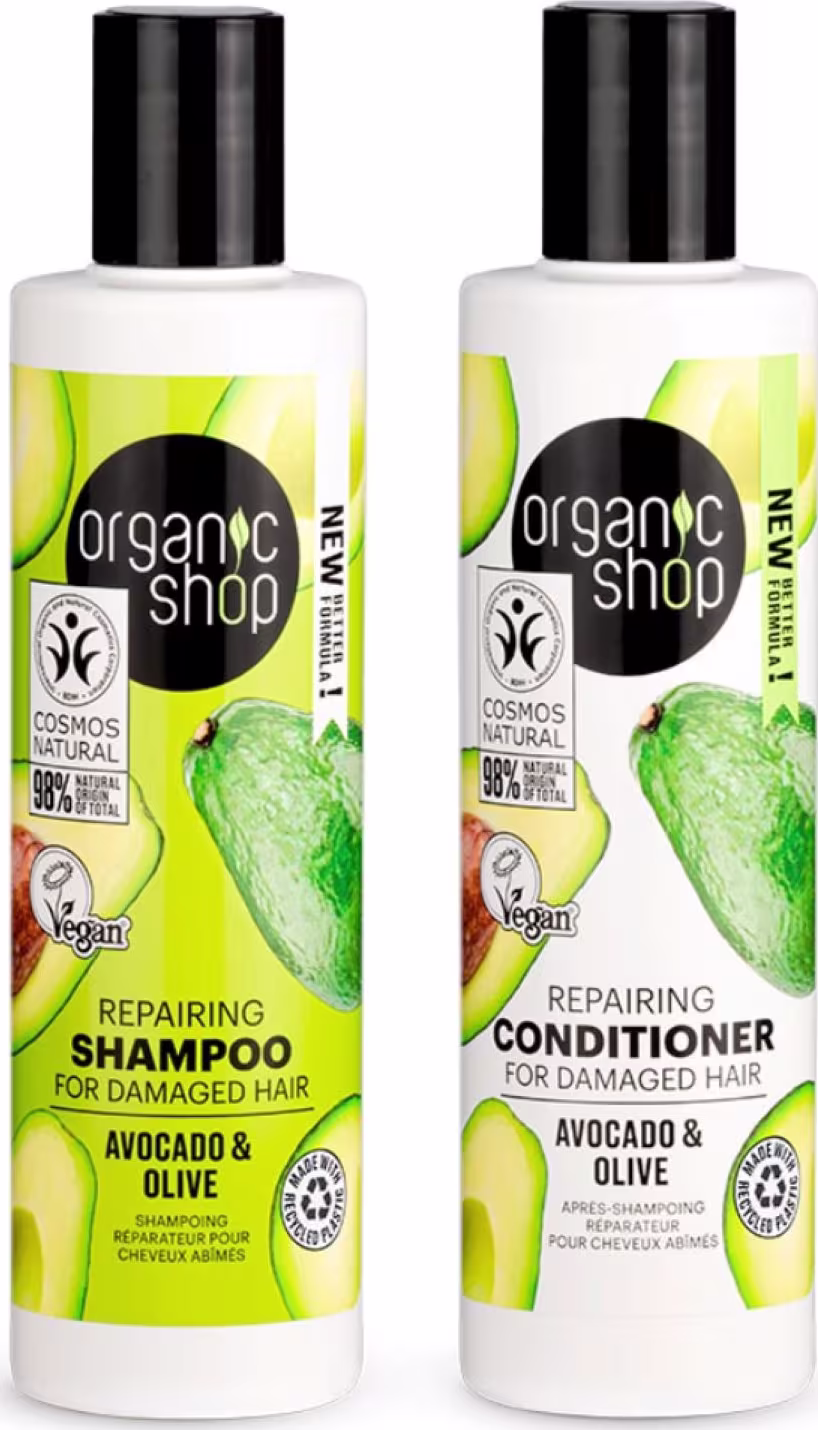 A imagem mostra um shampoo e condicionador em frascos brancos com tampa preta. O rótulo do shampoo é verde e traz abacates estampados. O frasco do condicionador é branco e também traz abacates estampados.