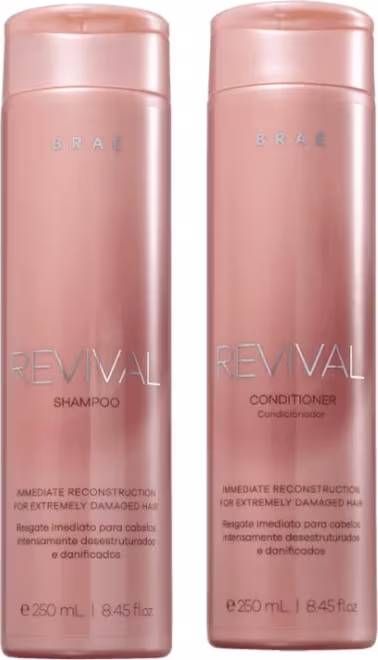 Dois frascos de produtos Braé Revival, um shampoo e um condicionador, com embalagens em tons de rosa claro. Os rótulos indicam que são produtos de reconstrução imediata para cabelos extremamente danificados.