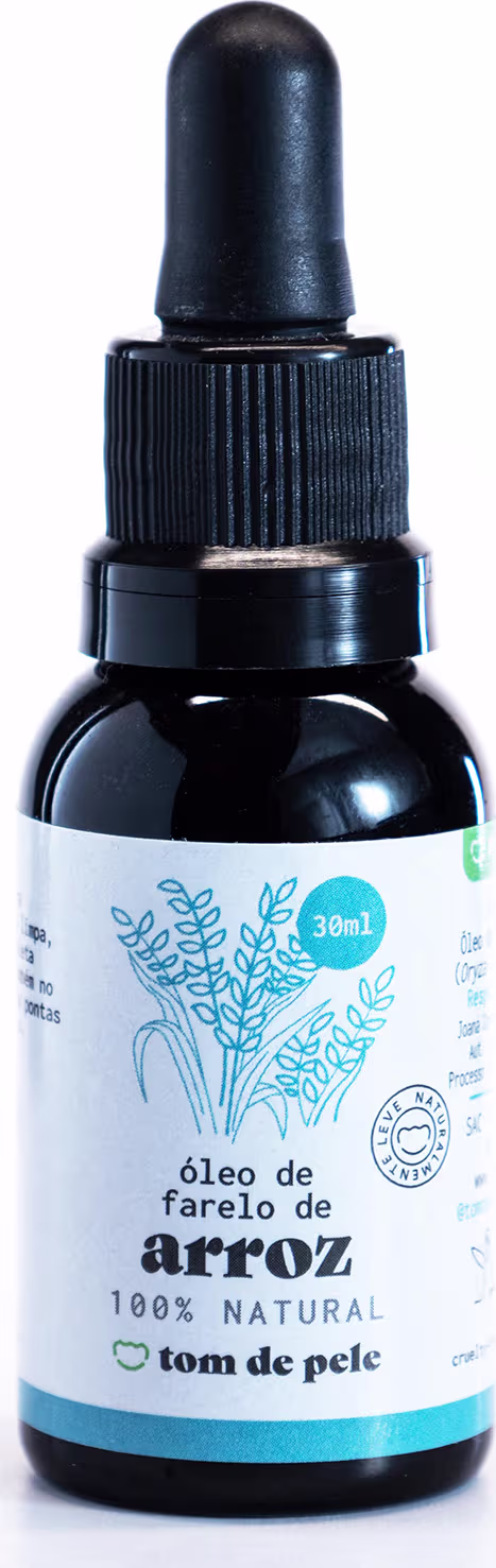 Óleo de farelo de arroz da marca Tom de Pele. O frasco é de vidro escuro com um conta-gotas preto na parte superior. O rótulo é branco com ilustrações de folhas e uma indicação de que o produto é 100% natural. O conteúdo é de 30ml