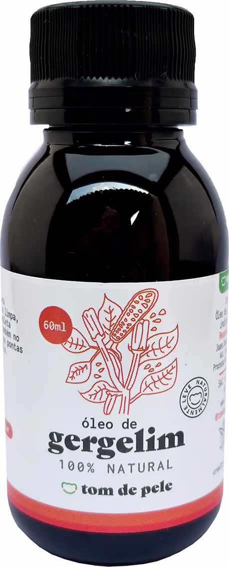 Óleo de gergelim 100% natural da marca Tom de Pele. O frasco é de vidro escuro com um rótulo branco e laranja, contendo informações sobre o produto.