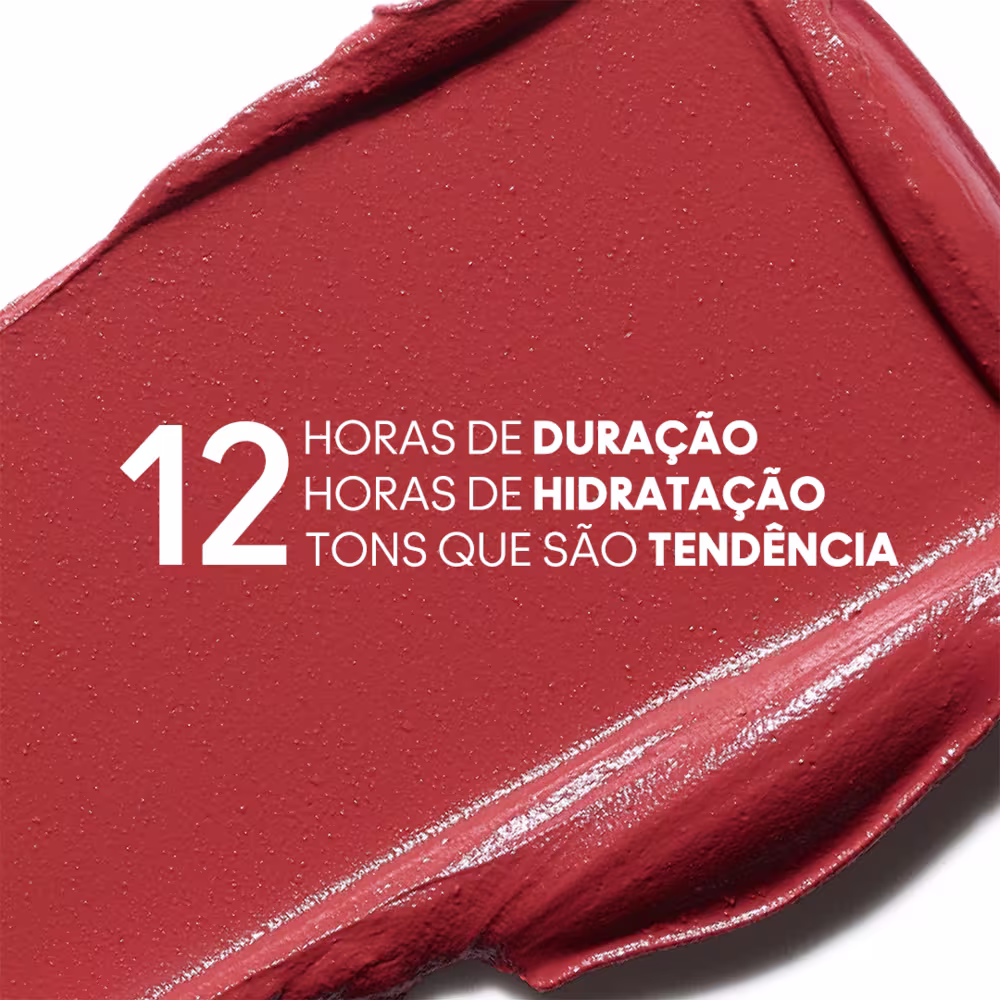A imagem mostra um pouco do produto espalhado em um fundo branco com informações escrito em branco, em cima do produto, sobre as 12 horas de duração, hidratação e 12 tons da coleção.
