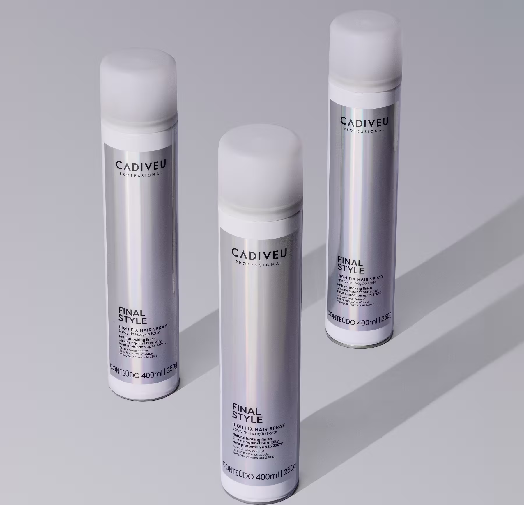 A imagem mostra três Sprays Fixadores Cadiveu Professional Final Style High Fix com uma cor prateada e branca, texto em preto, formato alongado e tampa branca.