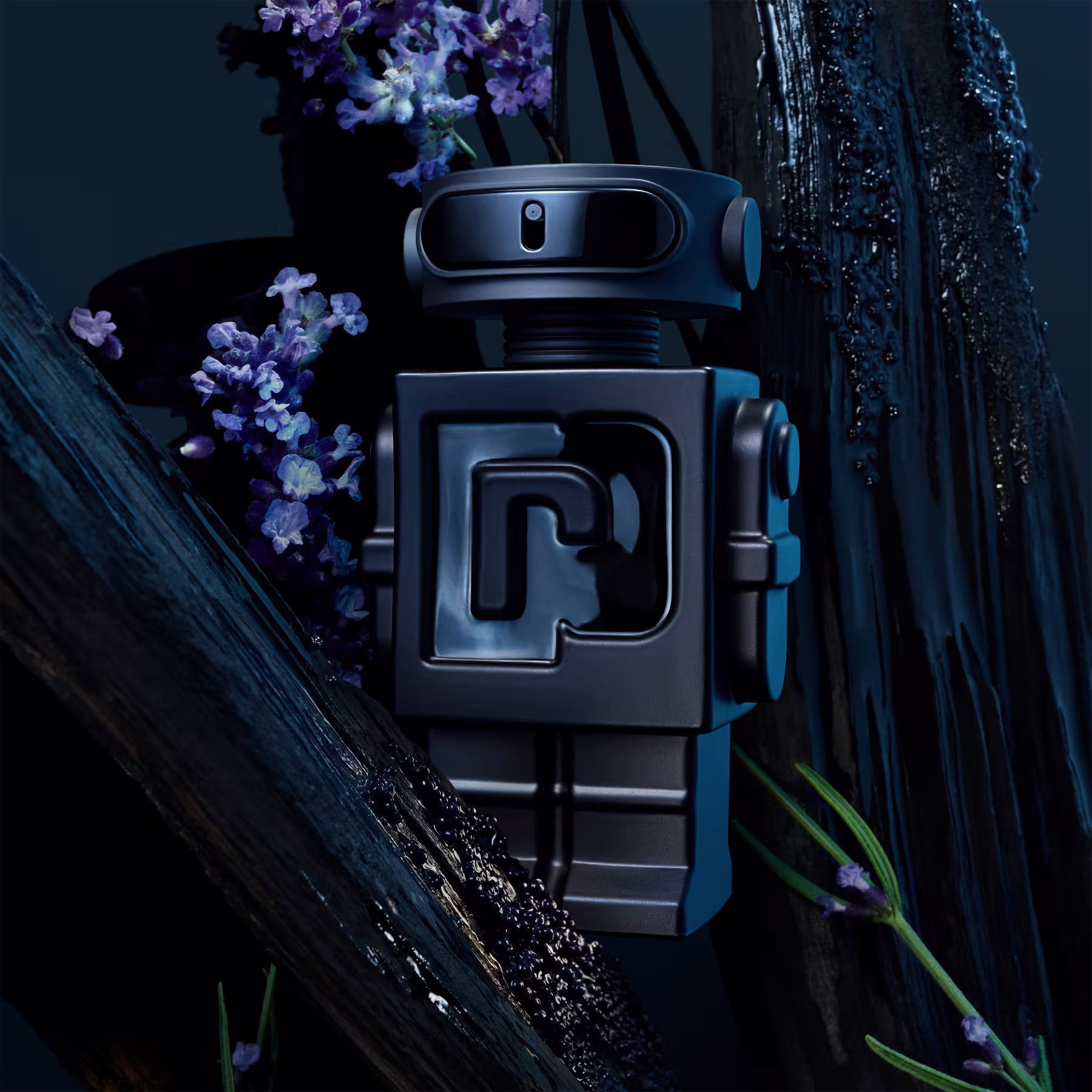 Frasco de perfume em formato de robô futurista, predominantemente na cor preta com detalhes em azul claro. Ele tem uma forma retangular compacta, com uma câmera ou sensor visual na parte superior. Na frente, há o logotipo em relevo com o formato de um "P"