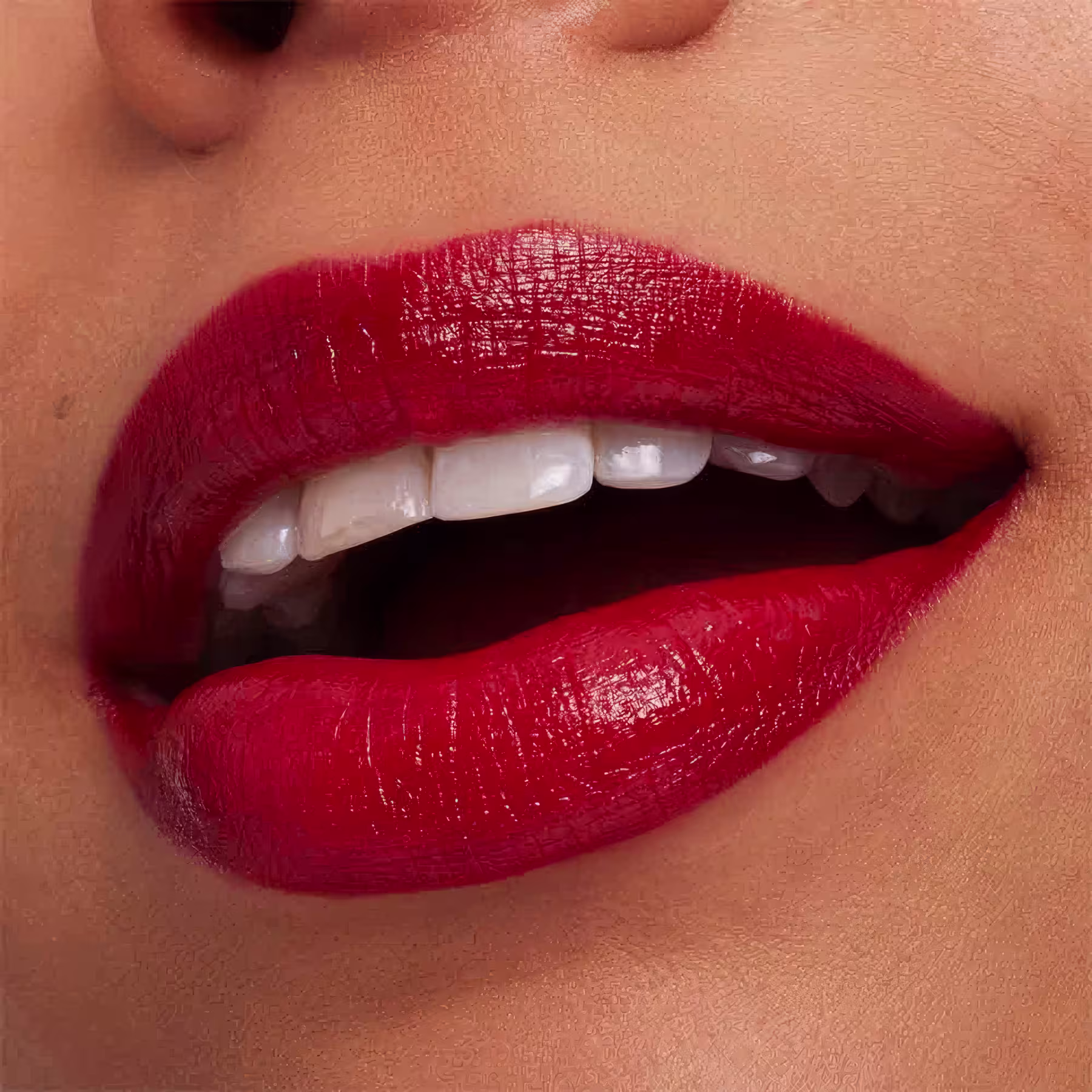 A imagem mostra a boca de uma mulher usando o batom.