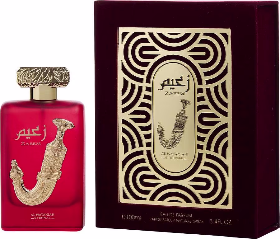 Frasco de perfume vermelho com detalhes dourados em caixa decorativa com padrões geométricos pretos e dourados. O rótulo exibe o nome "Zaeem" e a inscrição "Al Wataniah".