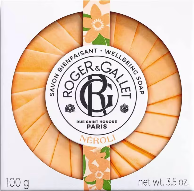 Sabonete em barra da marca Roger & Gallet, com embalagem circular em tons de laranja e branco, exibindo o logotipo da marca e a fragrância "Néroli". O produto possui 100g e é apresentado em uma caixa com informações sobre a marca e o produto.