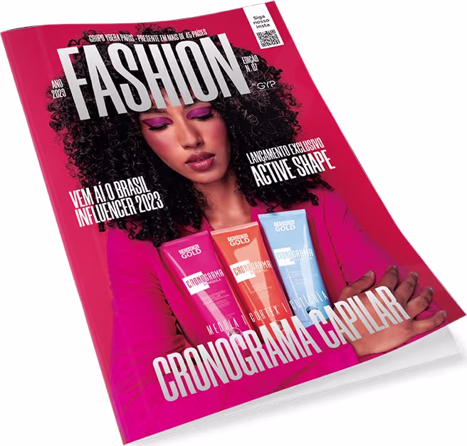 A revista de moda apresenta uma mulher com cabelos cacheados em destaque, exibindo produtos da marca Fashion Gold, incluindo embalagens em cores vibrantes de rosa e laranja.