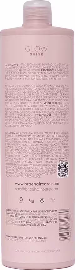 Shampoo Glow Shine da marca Brae. Embalagem na cor rosa claro. Rótulo com texto descritivo em português e inglês, detalhando instruções de uso, ingredientes e informações do fabricante. Formato cilíndrico com tampa rosqueada na parte superior.