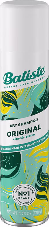 Shampoo seco da marca Batiste, na versão "Original". A embalagem é cilíndrica, de cor branca, com detalhes em verde e amarelo. Possui um design gráfico com elementos estilizados, sugerindo uma limpeza suave e refrescante dos cabelos.