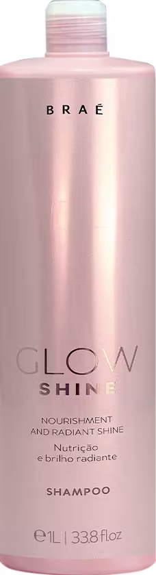 Shampoo Glow Shine da marca Braé. Embalagem plástica cilíndrica rosa claro perolado. Rótulo preto com o nome da marca "BRAÉ" em letras maiúsculas e "GLOW SHINE" abaixo em letras menores.