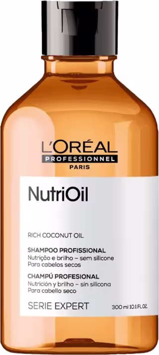 A imagem mostra um frasco arredondado de shampoo de cor amarelo, com rótulo branco e tampa preta.