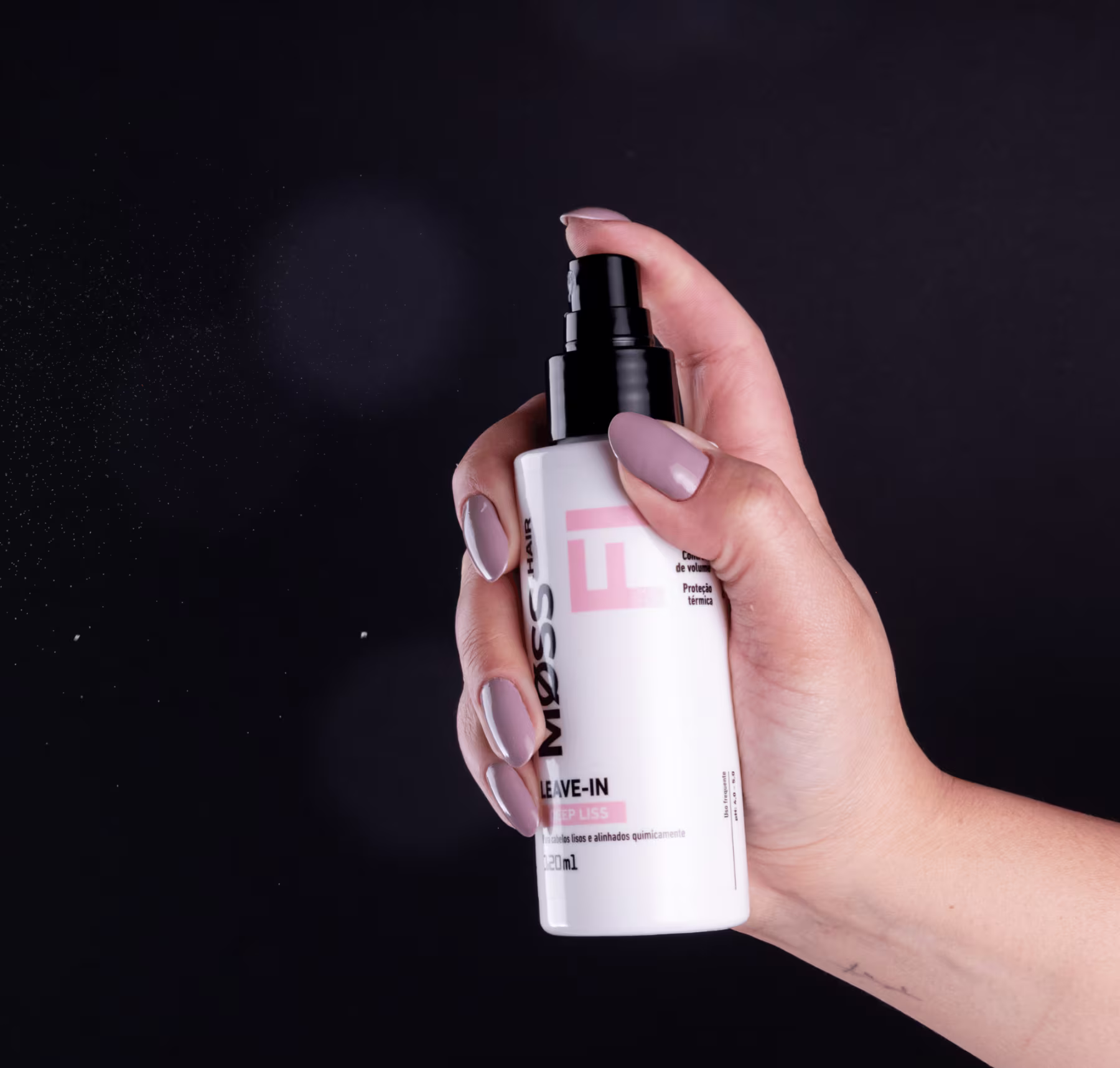 A imagem mostra uma mão segurando o frasco do leave-in deep liss, pressionando a tampa borrifadora.
