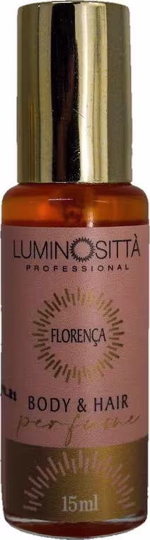 Apresenta pequeno frasco de perfume para corpo e cabelos da marca Luminositta Professional. O frasco é laranja, com detalhes em dourado.