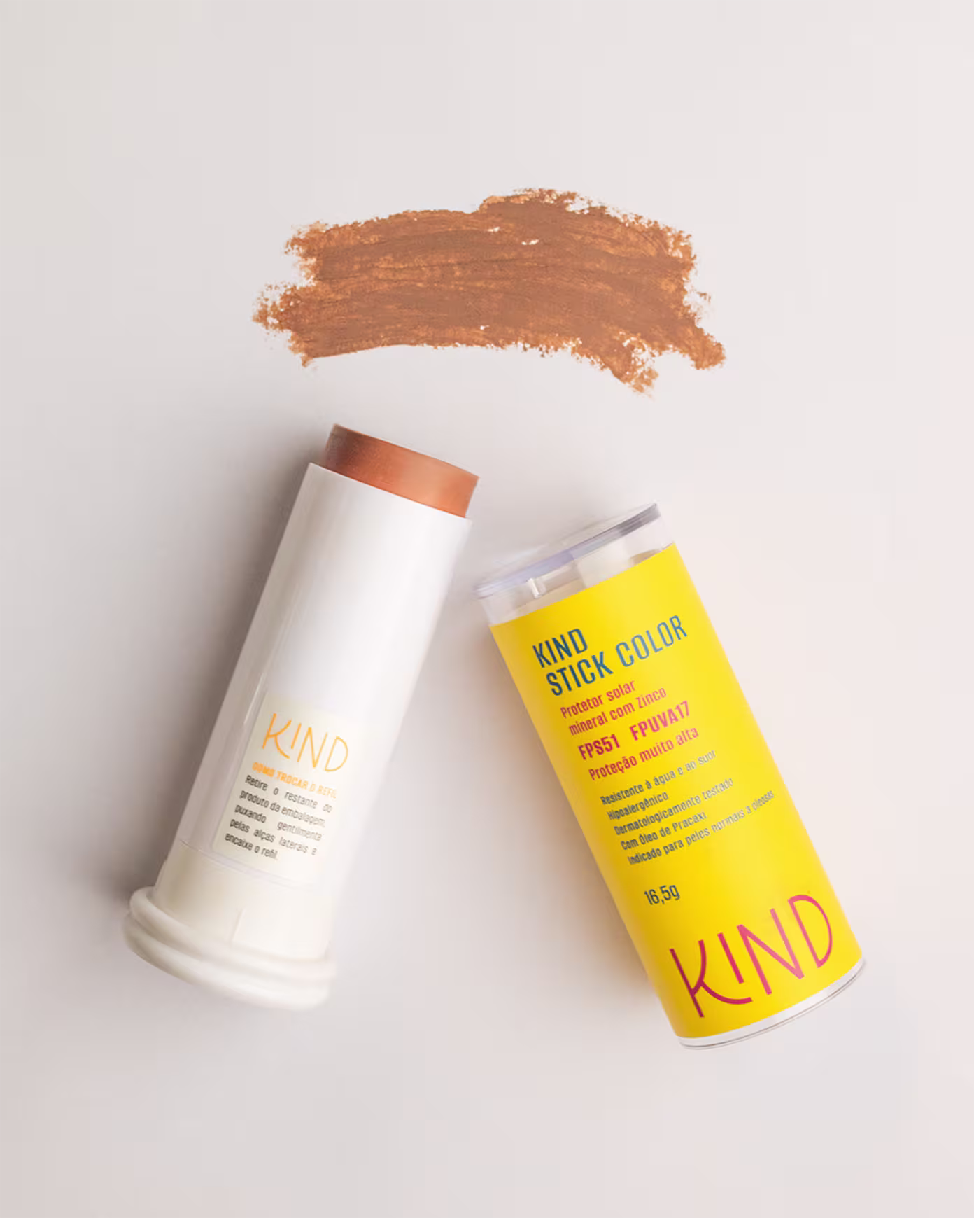 A imagem mostra o protetor solar aberto, com a embalagem do lado esquerdo e a tampa do lado direito, e, acima, uma amostra da cor e textura do produto. Tudo isso em fundo branco.