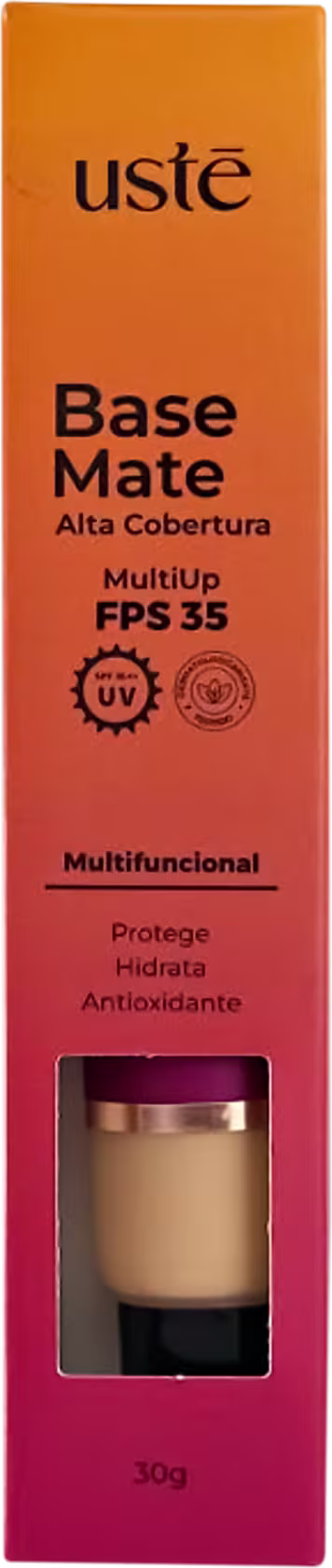 Base Mate em embalagem retangular laranja. Rótulo preto com o nome do produto "Base Mate" e informações como "MultiUp FPS 35", "Multifuncional", "Protege, Hidrata, Antioxidante". Pequena janela mostra o produto a cor bege da base.