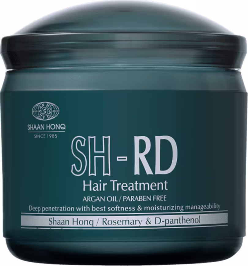 A imagem mostra o tratamento capilar em um pote plástico arredondado de cor verde escura.