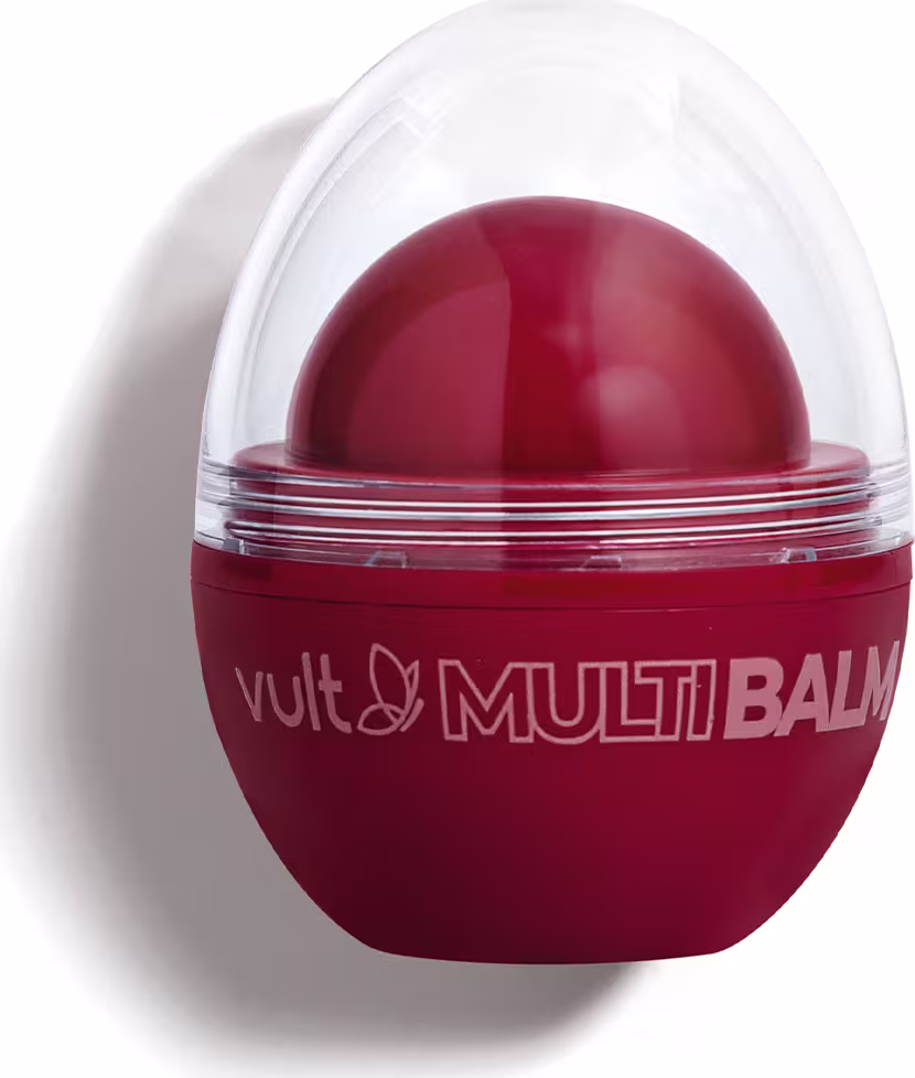 Produto de beleza Vult em embalagem vermelha com cúpula transparente, contendo um bálsamo de cor vermelha em seu interior. O rótulo exibe o nome "Vult Multi Balm" em destaque.