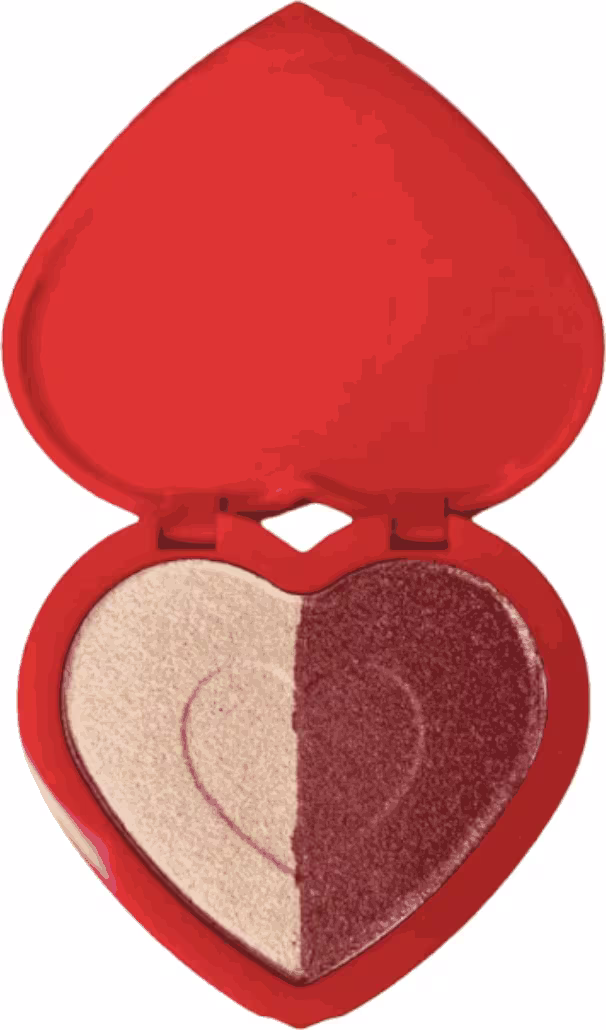 Iluminador em formato de coração, com uma embalagem vermelha brilhante. A embalagem possui uma divisão interna, com uma metade em tom bege e a outra em tom marrom avermelhado.