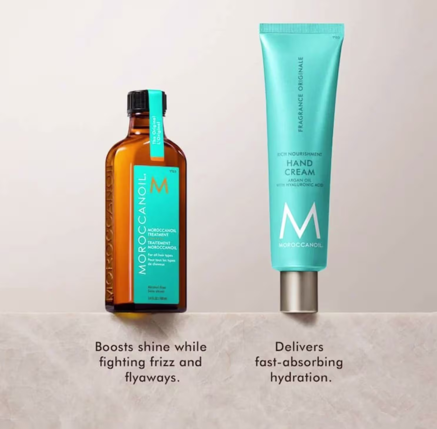 Dois produtos Moroccanoil: um frasco de tratamento de cabelo de cor âmbar e um tubo de creme para as mãos de cor turquesa, com rótulos destacando os benefícios de brilho e hidratação.
