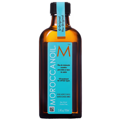 Óleo de tratamento capilar Moroccanoil em frasco âmbar de 100ml. Embalagem com tampa preta e rótulo azul com o logotipo "M" em laranja e texto "Oil treatment for all hair types".