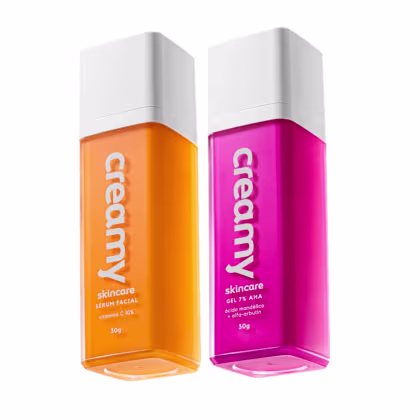 Dois frascos de produtos de skincare da marca Creamy, um de cor laranja com Vitamina C outro de cor rosa com Ácido Mandélico.
