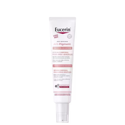 A imagem mostra uma embalagem tubular branca com rótulo em espanhol e português. Cores predominantes são branco, preto e vermelho.