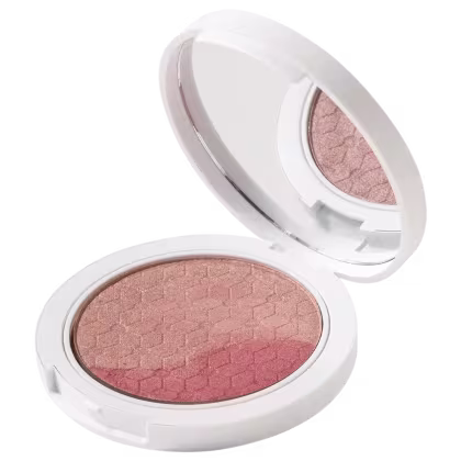 Blush em Pó Multifuncional em embalagem redonda branca. A parte interna removível revela uma superfície de pó prensado em tom rosado terroso.